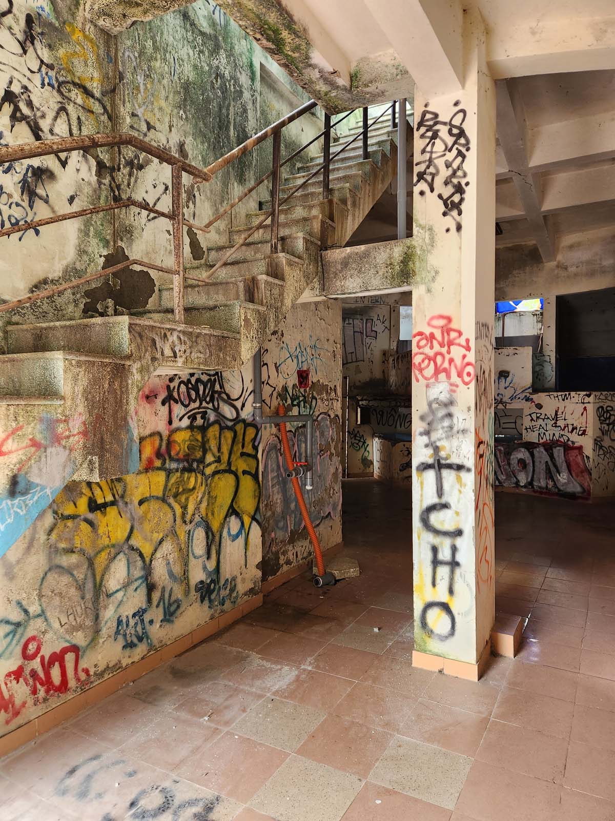 Narrow steps to the second floor seen dimly from below.