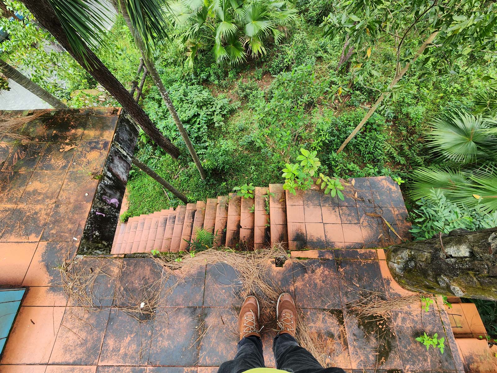 A photo aimed at Damian's feet, perilously close to the crumbling, rail-less edge of the slide boarding platform.