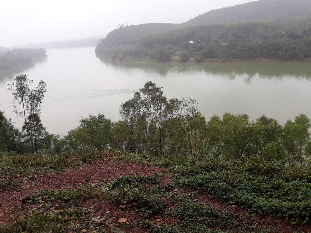 A picture of hills beyond a river covered in mist.